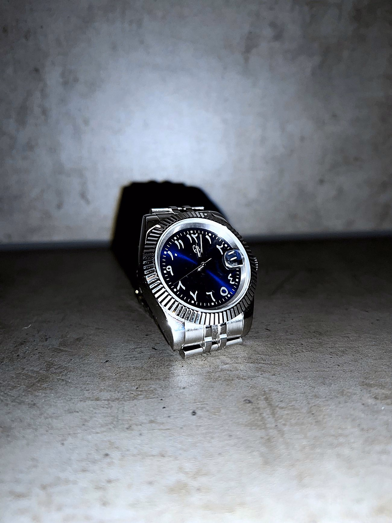 6F7 Azure watch with blue dial, Arabic-Indic numerals and silver-toned bracelet.